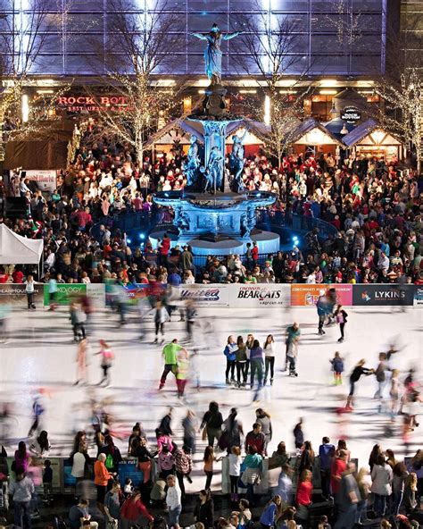 Fountain square ice skating - Jackie Hanna, right, straps ice skates onto Hudson McAllister, both of Fort Thomas, Ky., on Thursday, Dec. 14, 2023, at the UC Health Ice Rink presented by Fifth Third at Fountain Square in ...